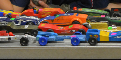 Closeup of several BSA Pinewood Derby cars